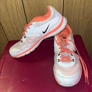 White and pink/coral Nike athletic shoes